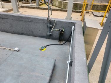 Leak point sensor installation below sulfuric acid piping and around the trench