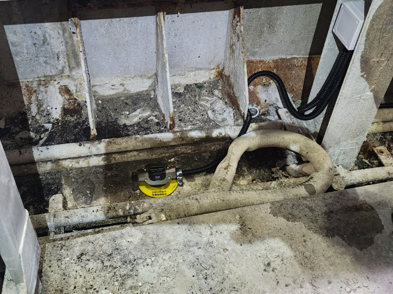 Detailed view of completed leak detector installation and wiring finish